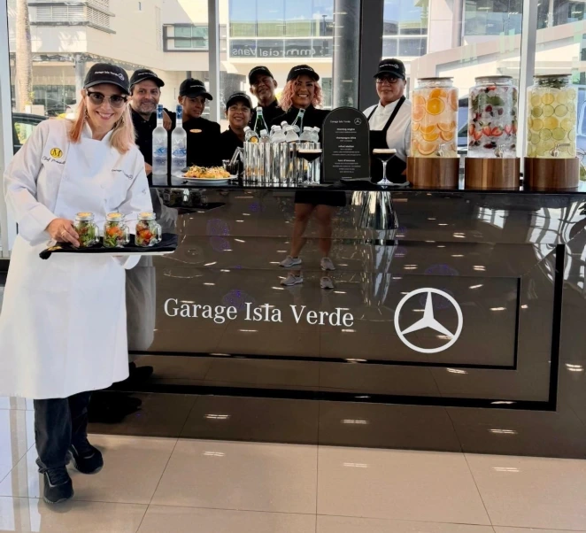 Professional Chef Marisoll Events catering team attending a beverage bar with infused fruits at a corporate event.